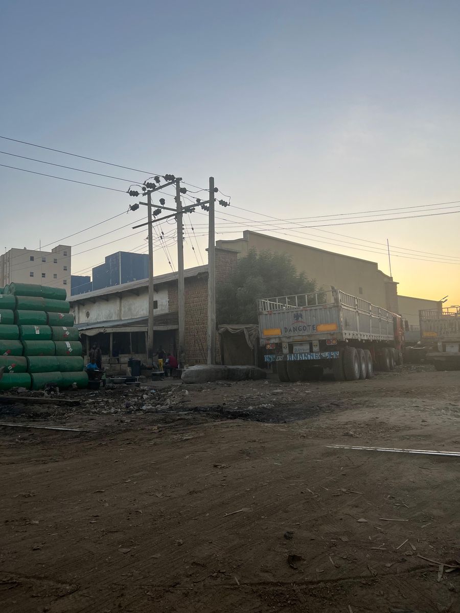 Haulage trucks loading at Singa Market, Kano at dusk